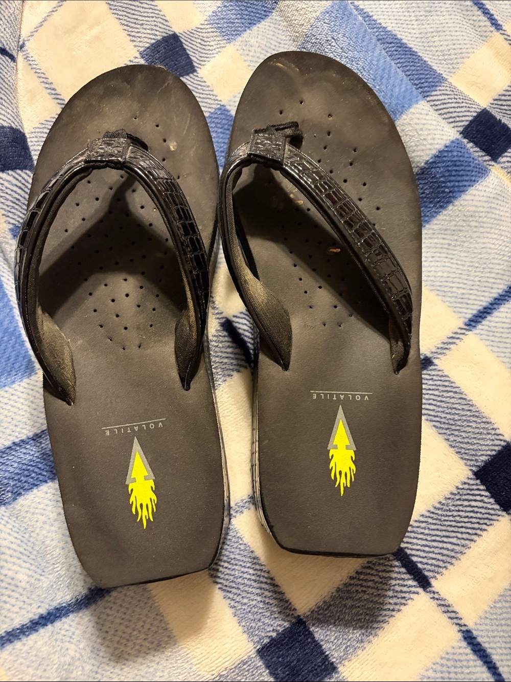 Volatile Black Flip Flop Sandals with Yellow Logo